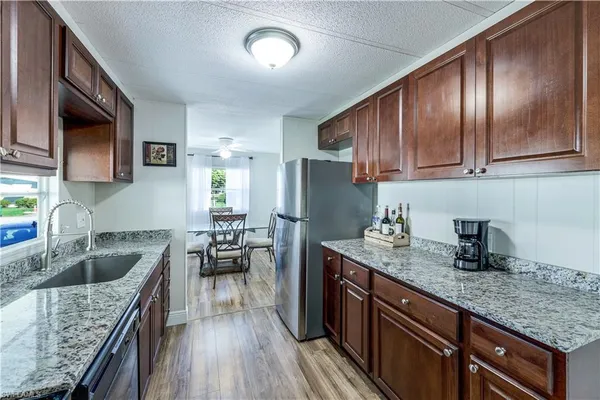 a kitchen with granite countertop lots of counter top space cabinets and stainless steel appliances