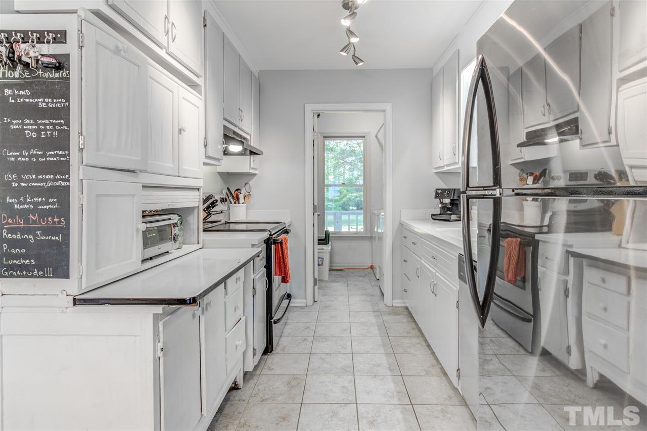 2724 Quail Point Drive Raleigh, NC 27603 - Photo 12 of 25 a kitchen with cabinets and stainless steel appliances