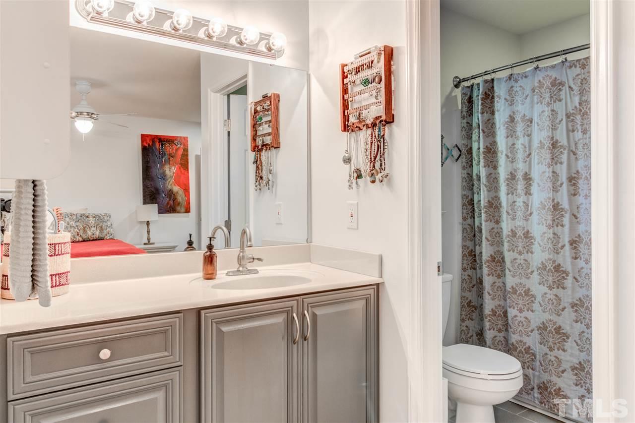 2724 Quail Point Drive Raleigh, NC 27603 - Photo 17 of 25 a bathroom with a sink a toilet and shower curtain