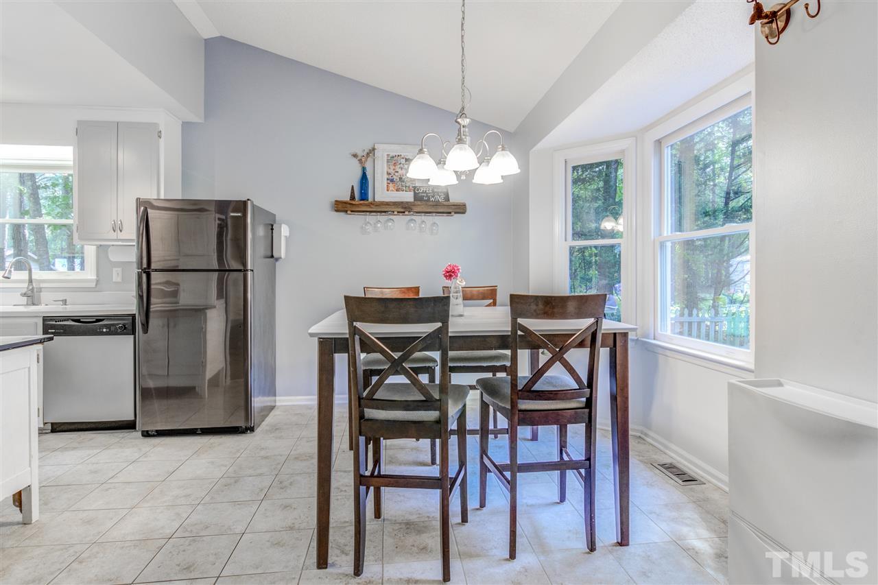 2724 Quail Point Drive Raleigh, NC 27603 - Photo 10 of 25 a dining room with furniture a chandelier and window