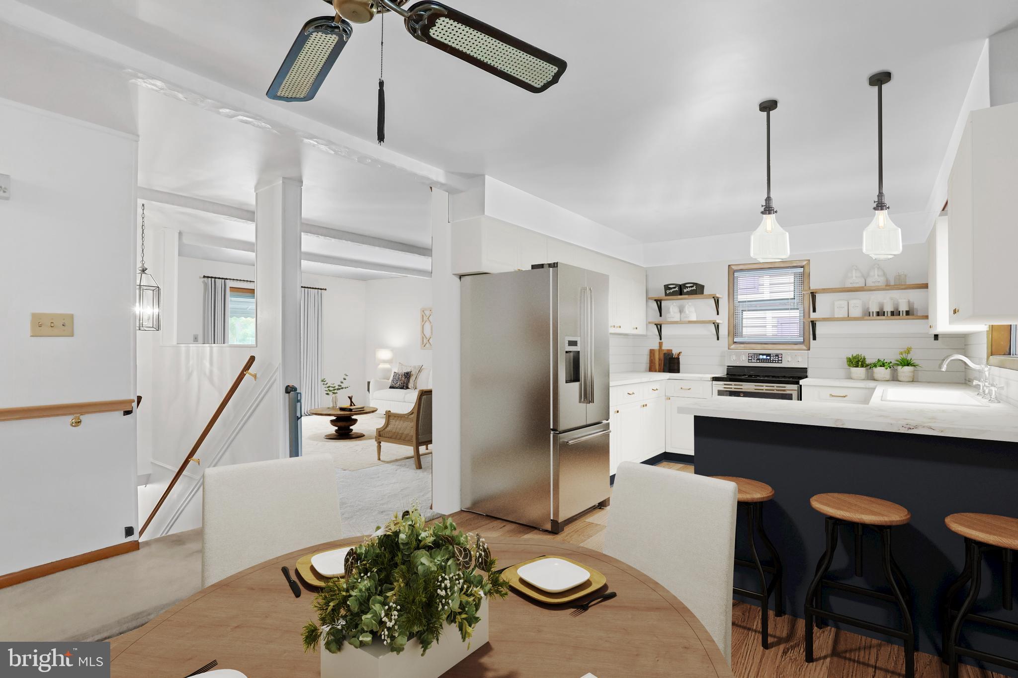 a kitchen with stainless steel appliances kitchen island granite countertop a sink refrigerator and cabinets