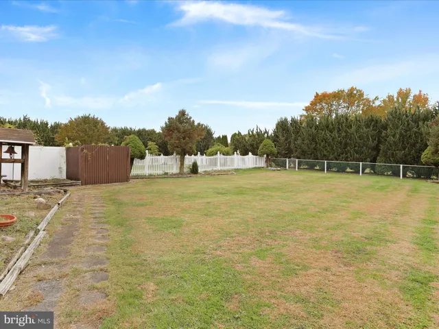 a swimming pool with an outdoor space and seating area