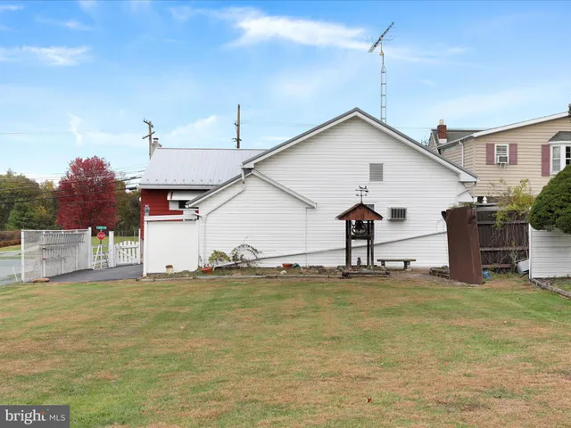 a view of a house with a yard and more windows