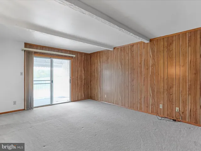a view of an empty room and a window