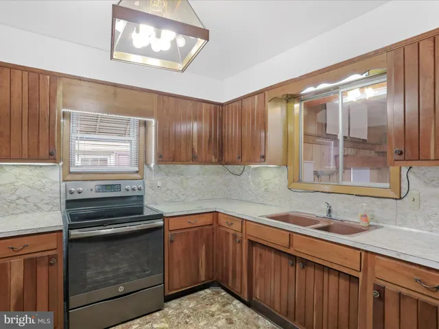 a kitchen with a sink stove and cabinets