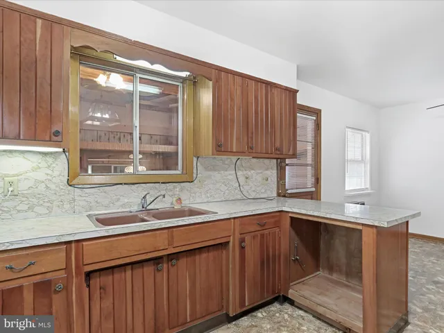 a kitchen with a sink and a window