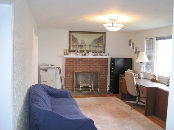 15 Tilden Road Canton, MA 02021 - Photo 9 of 23 a living room with furniture and a fireplace