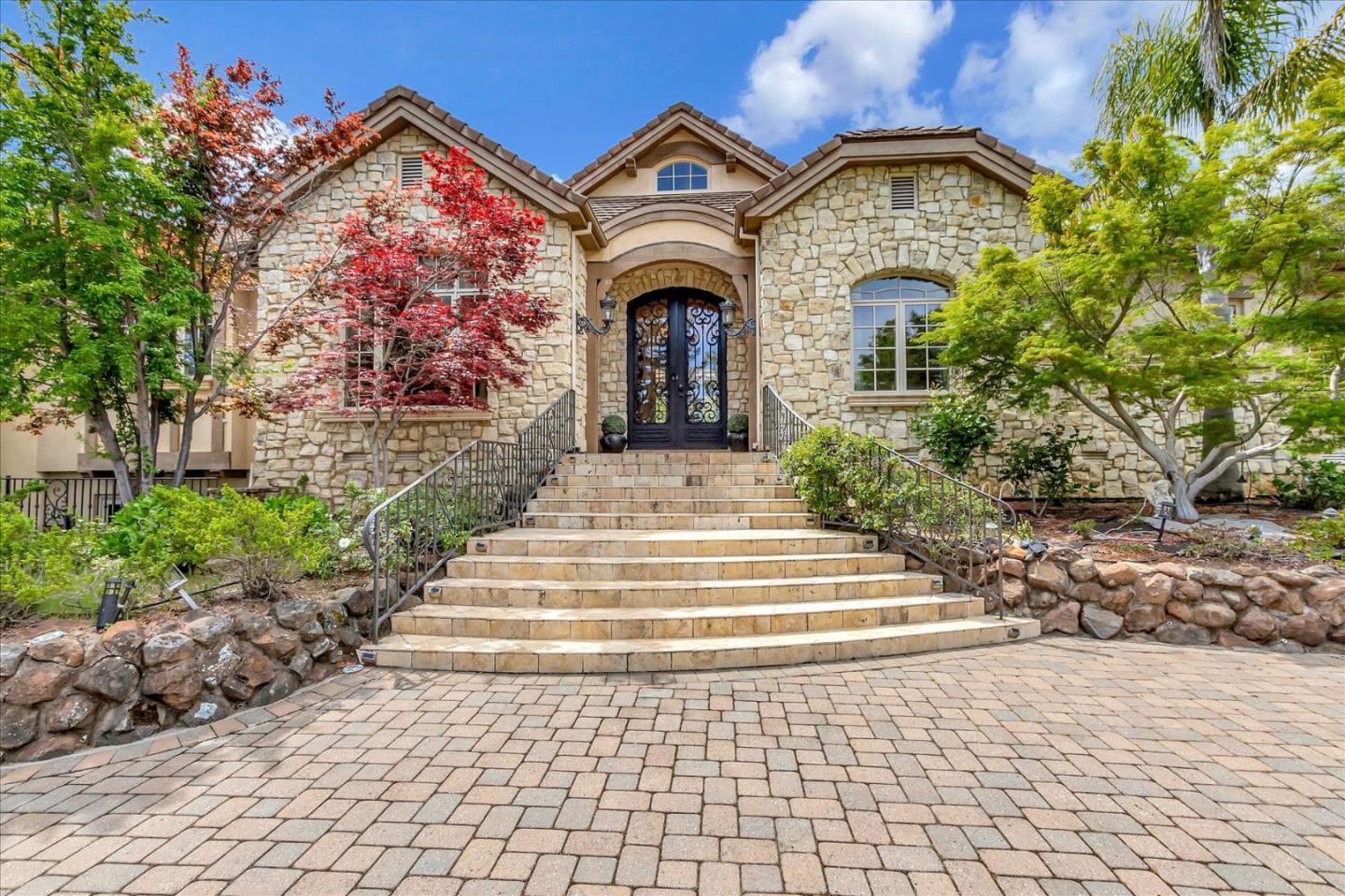a front view of a house with a garden