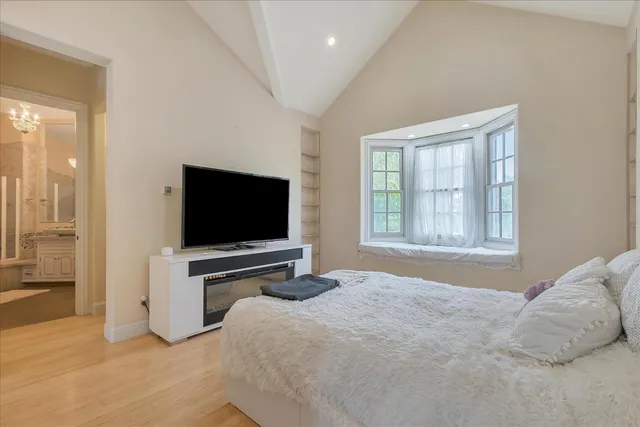 a spacious bathroom with a granite countertop sink and a mirror