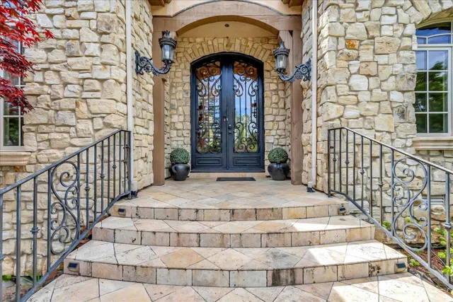 a view of a brick house with potted plants