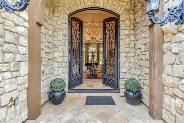 a view of a livingroom with furniture a chandelier and wooden floor