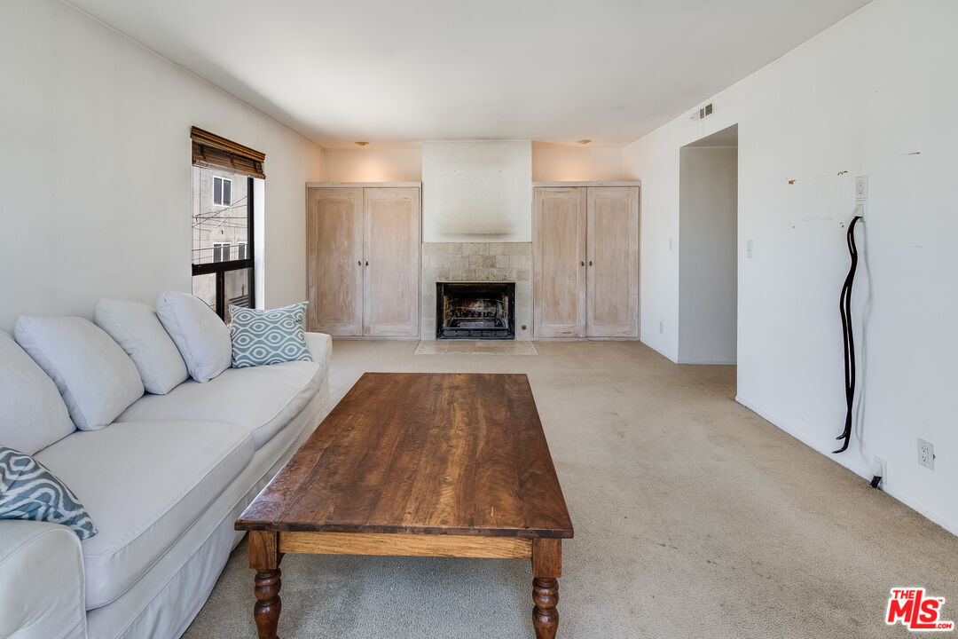 25 Hurricane Street, Unit 3 Marina del Rey, CA 90292 - Photo 23 of 27 a living room with furniture and a fireplace