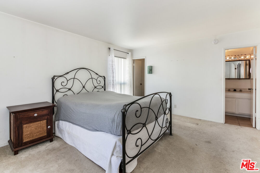 25 Hurricane Street, Unit 3 Marina del Rey, CA 90292 - Photo 9 of 27 a bedroom with a bed and a chair