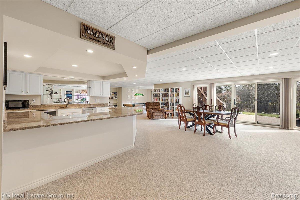 3571 Cedar Brook Drive Rochester, MI 48309 - Photo 51 of 57 Dining area featuring a paneled ceiling, plenty of natural light, light carpet, recessed lighting, and a tray ceiling