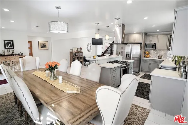 a large kitchen with a table and chairs