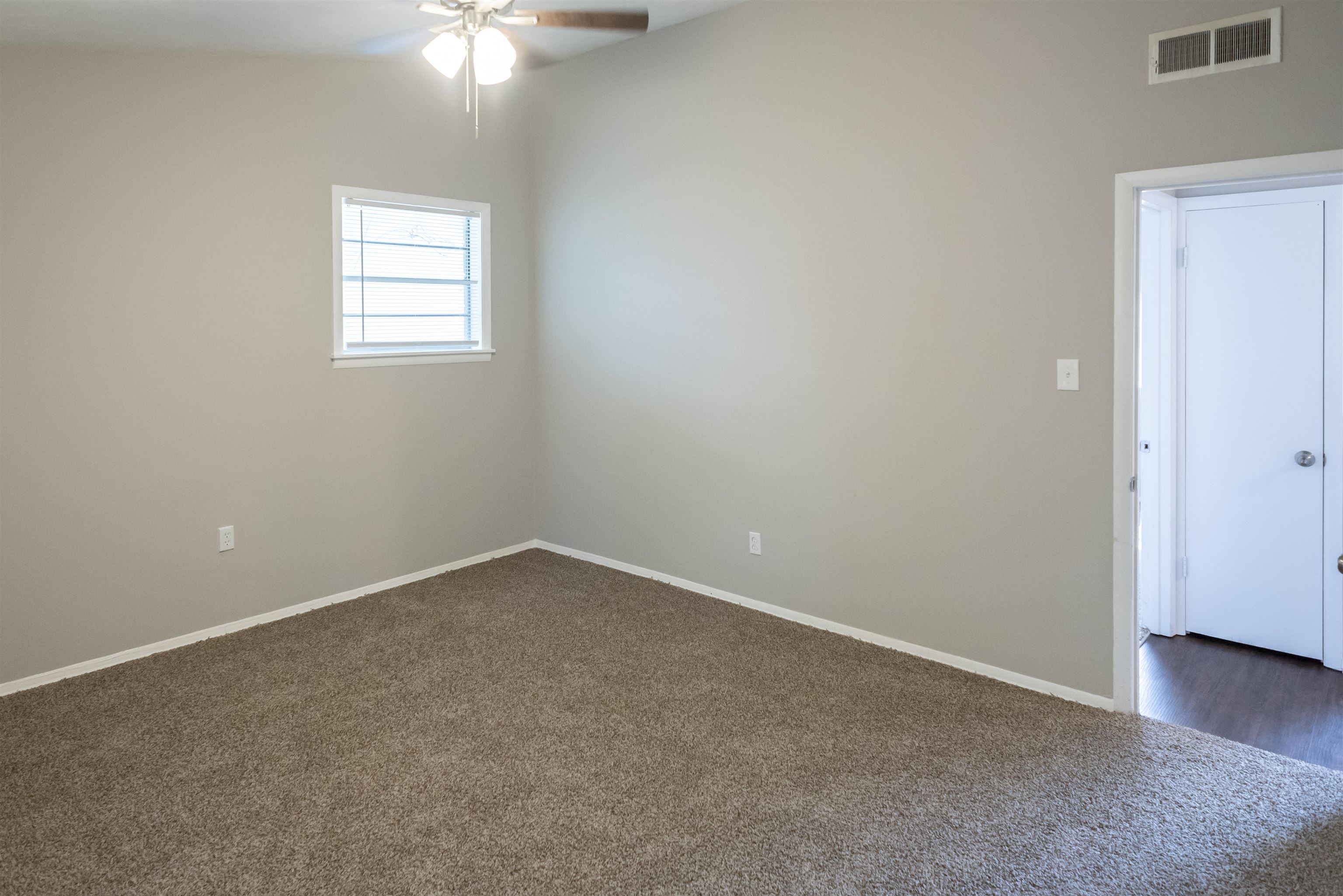 4622 Applegate Road Memphis, TN 38109 - Photo 2 of 13 an empty room with windows and fan