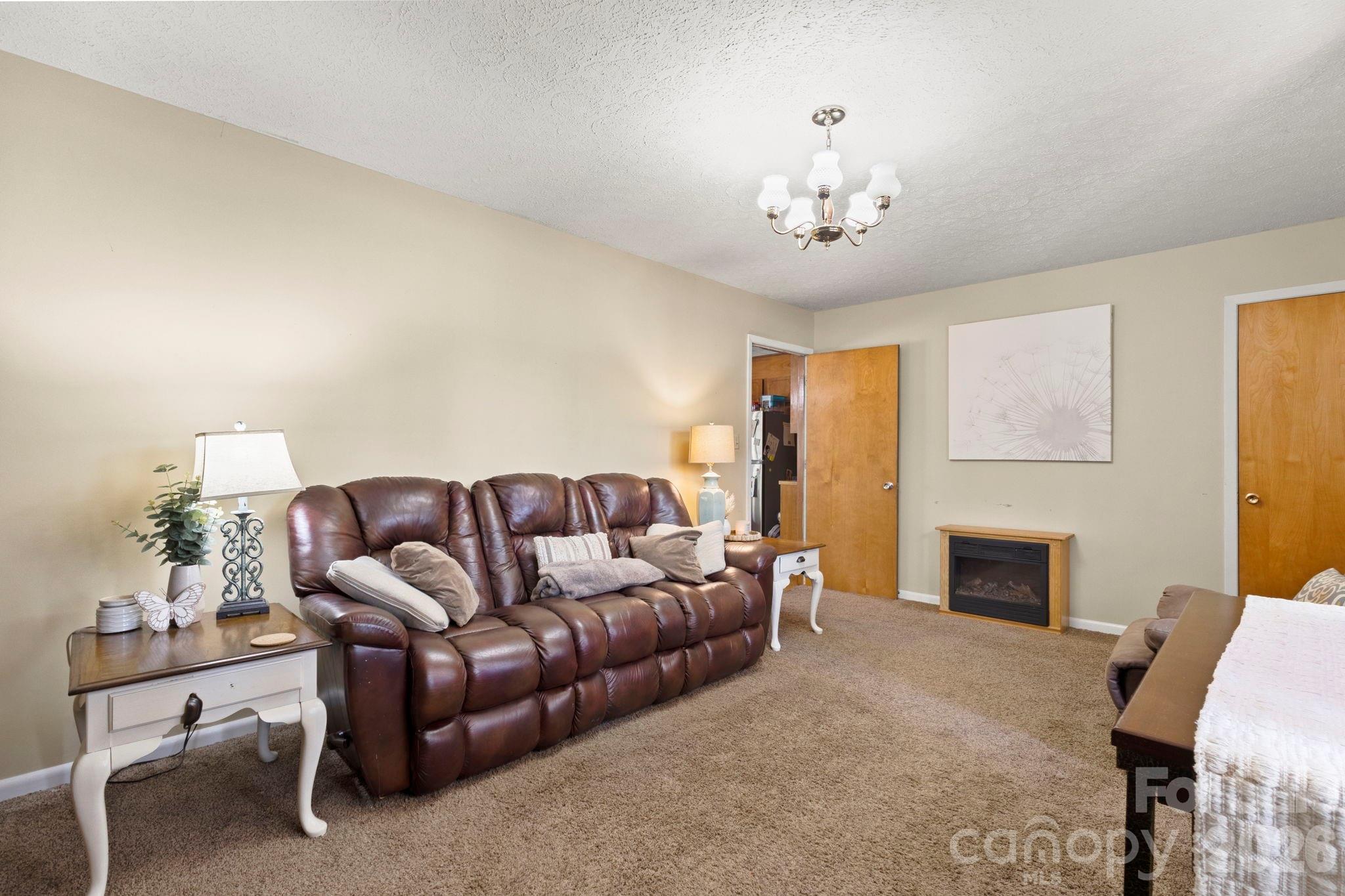 2200 Gaffney Road Shelby, NC 28152 - Photo 12 of 46 a living room with furniture a fireplace and a flat screen tv