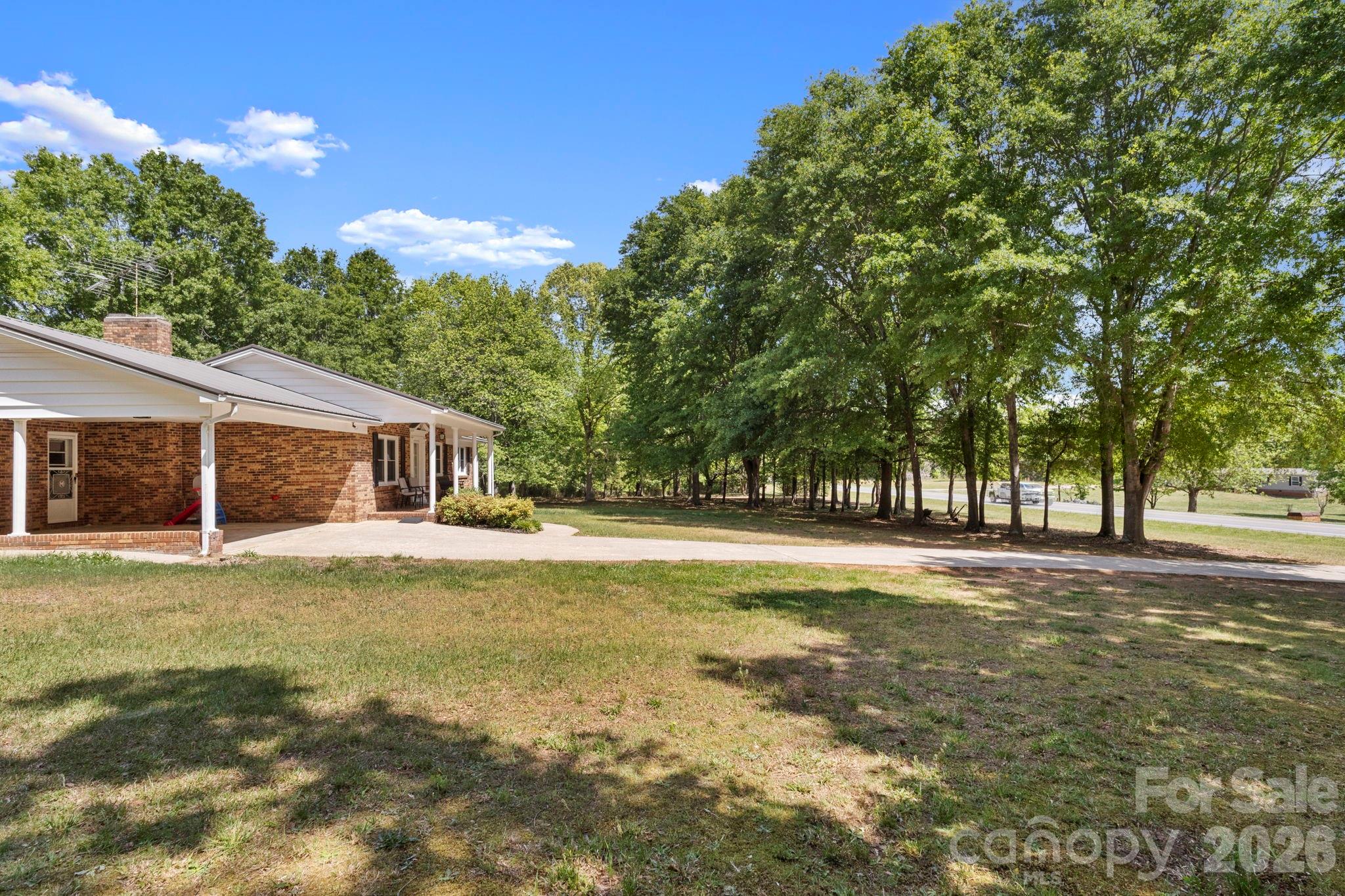 2200 Gaffney Road Shelby, NC 28152 - Photo 9 of 46 a view of a house with a big yard and large trees