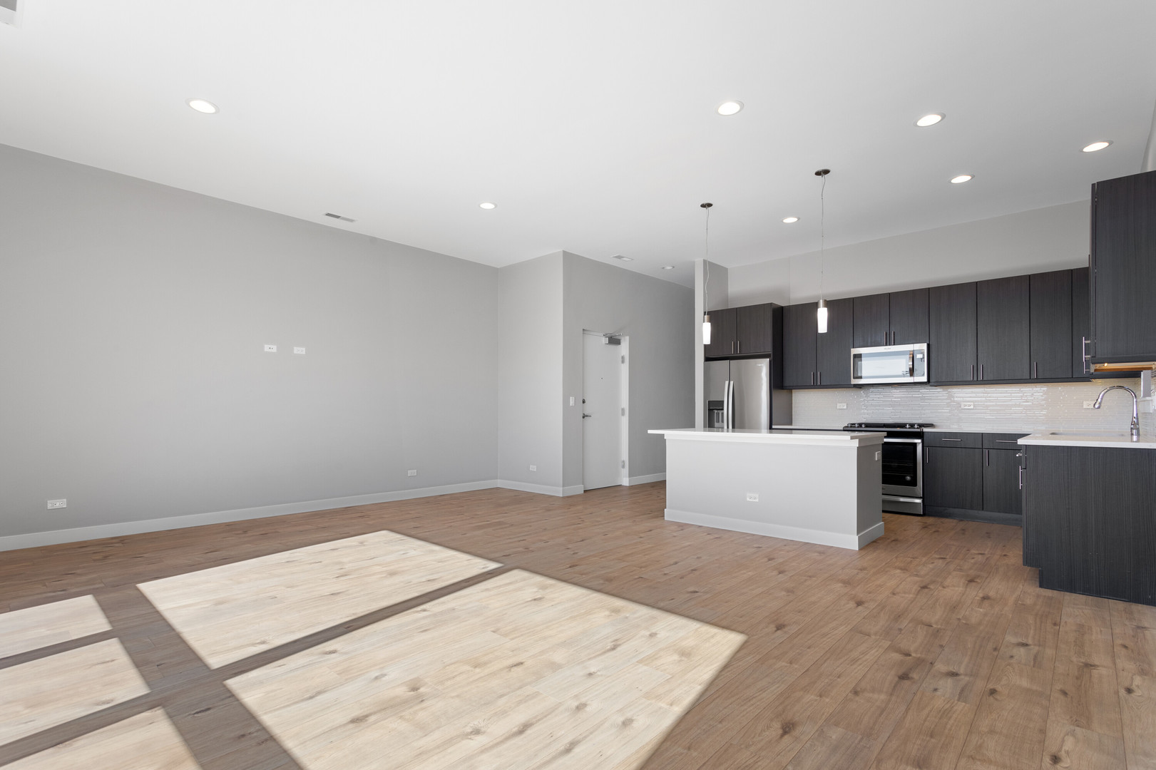 2532 West Addison Street, Unit 2E Chicago, IL 60618 - Photo 6 of 17 a large white room with a large window