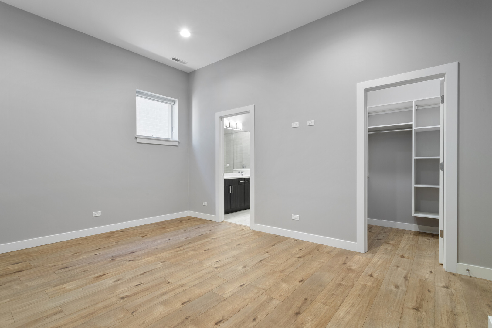 2532 West Addison Street, Unit 2E Chicago, IL 60618 - Photo 8 of 17 wooden floor in an empty room with a window