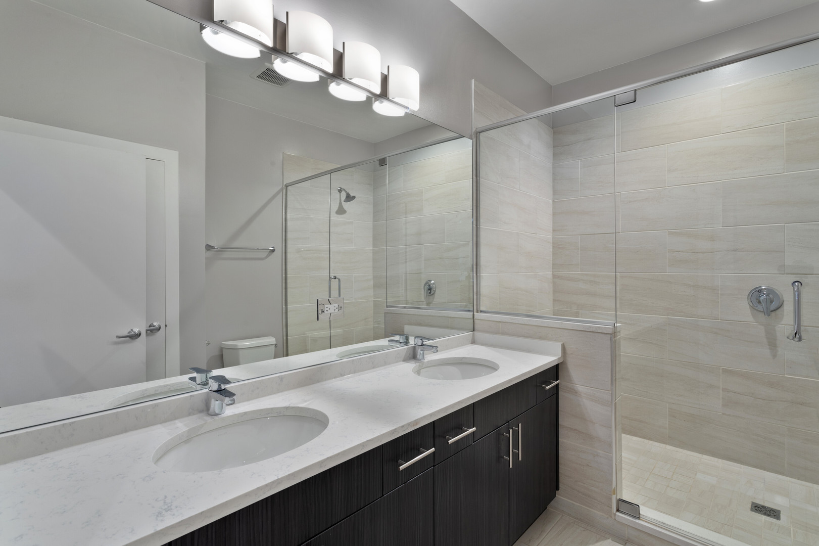 2532 West Addison Street, Unit 2E Chicago, IL 60618 - Photo 10 of 17 a bathroom with a sink double vanity and a mirror
