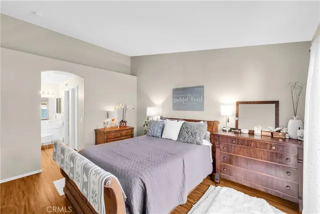 a bed room with bed and a chair