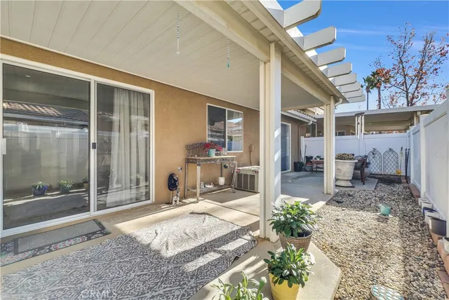 a view of a patio with table and chairs and potted plants