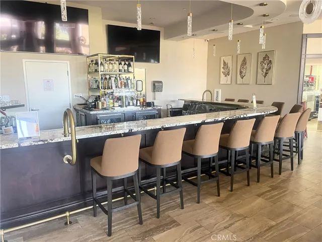 a living room with furniture a large window and stainless steel appliances