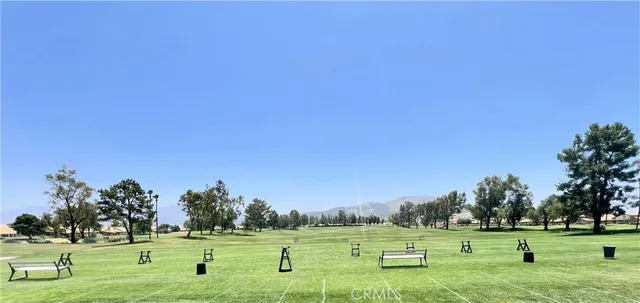 a large kitchen with kitchen island a stove a sink a dining table and chairs with wooden floor