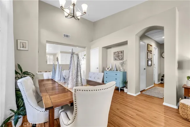 a dining room with furniture and wooden floor