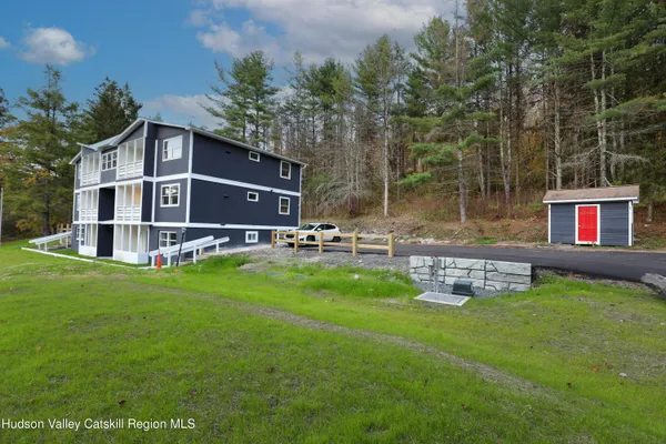 a front view of a house with a yard table and chairs
