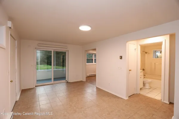 an empty room with windows and entrance