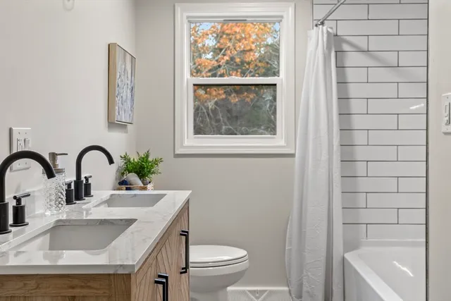 a bedroom with a bed and windows