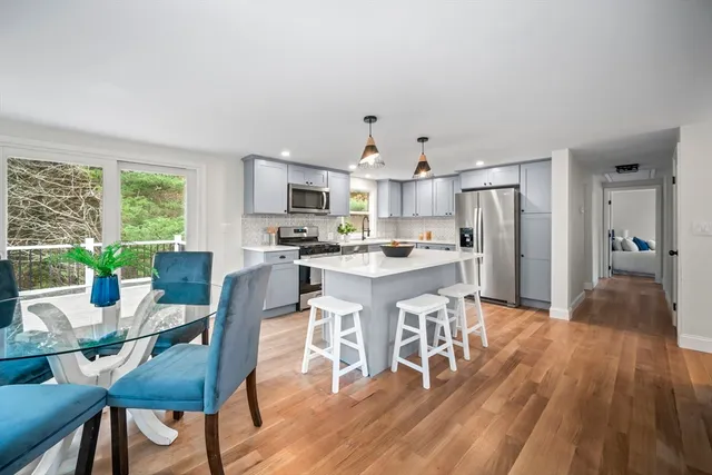 a view of a dining room with furniture and wooden floor
