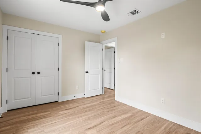 a view of an empty room and wooden floor