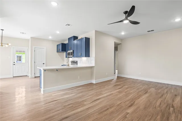 a view of kitchen with granite countertop cabinets and wooden floor
