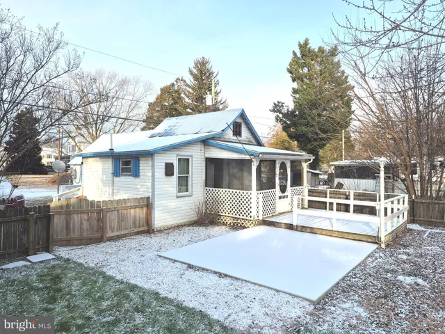 a front view of a house with a yard and potted plants