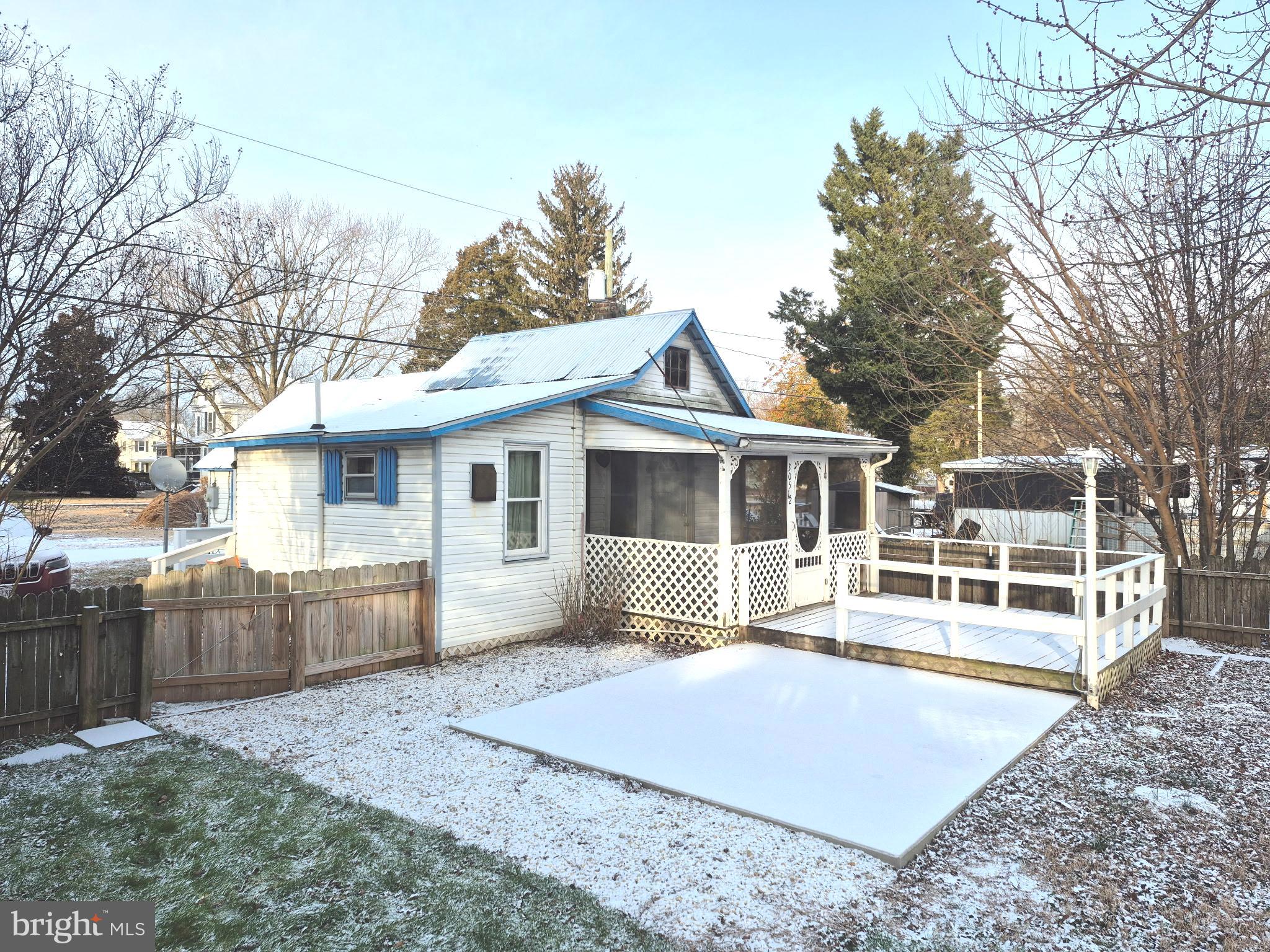 305 Maple Avenue Ridgely, MD 21660 - Photo 1 of 7 a front view of a house with a yard and potted plants
