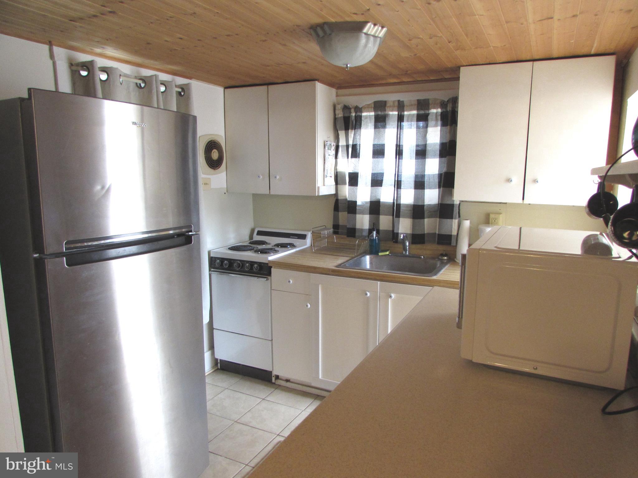 305 Maple Avenue Ridgely, MD 21660 - Photo 5 of 7 a kitchen with a refrigerator and a sink
