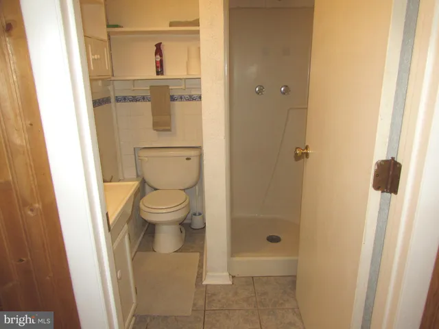a view of a room with wooden floor and a window
