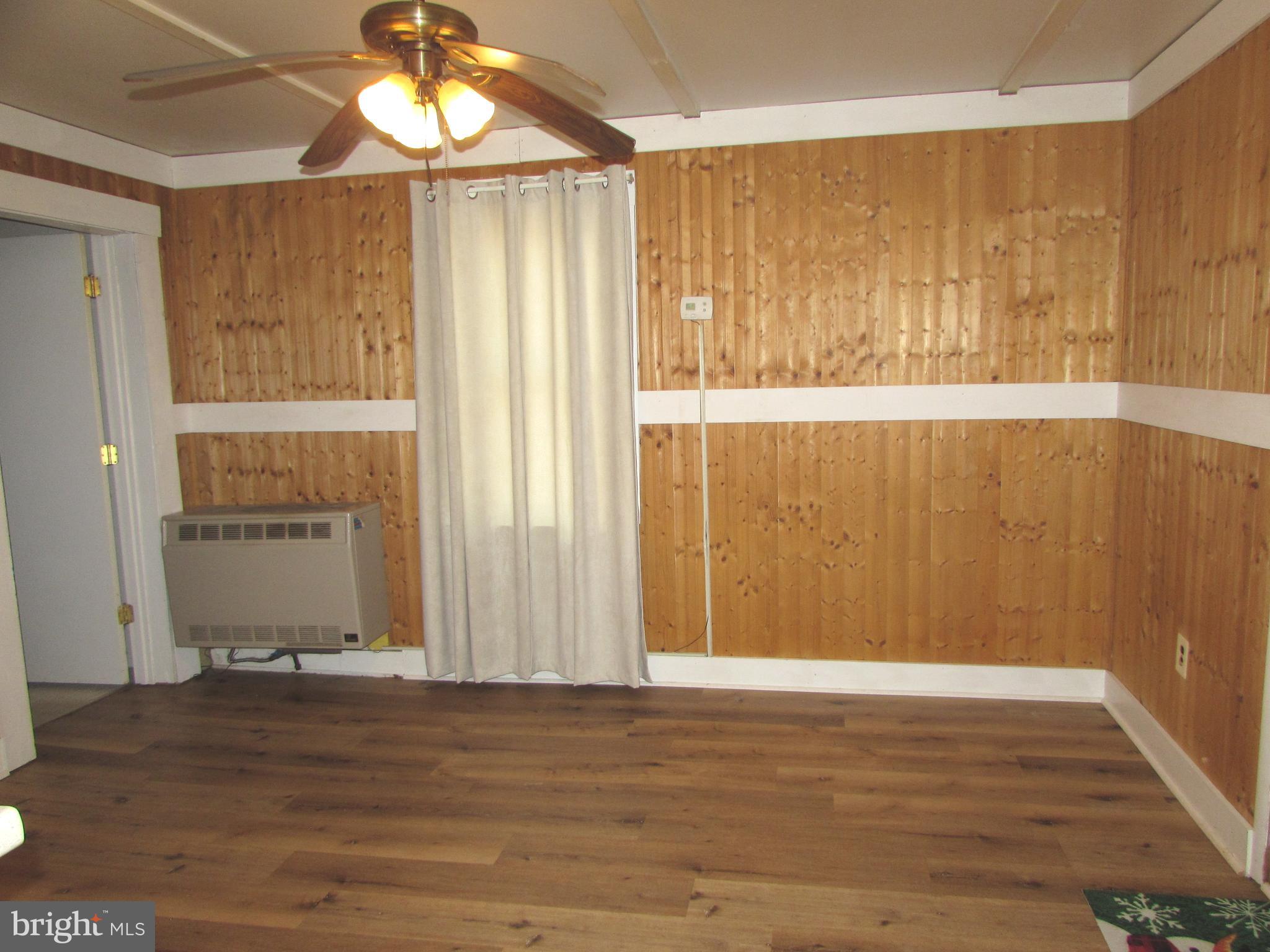 305 Maple Avenue Ridgely, MD 21660 - Photo 7 of 7 a view of a room with wooden floor and a window