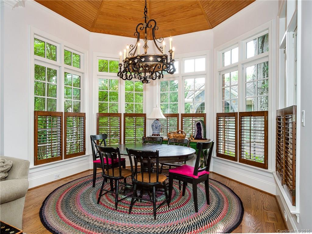 2419 Overhill Road Charlotte, NC 28211 - Photo 11 of 24 a dining room with furniture a chandelier and wooden floor
