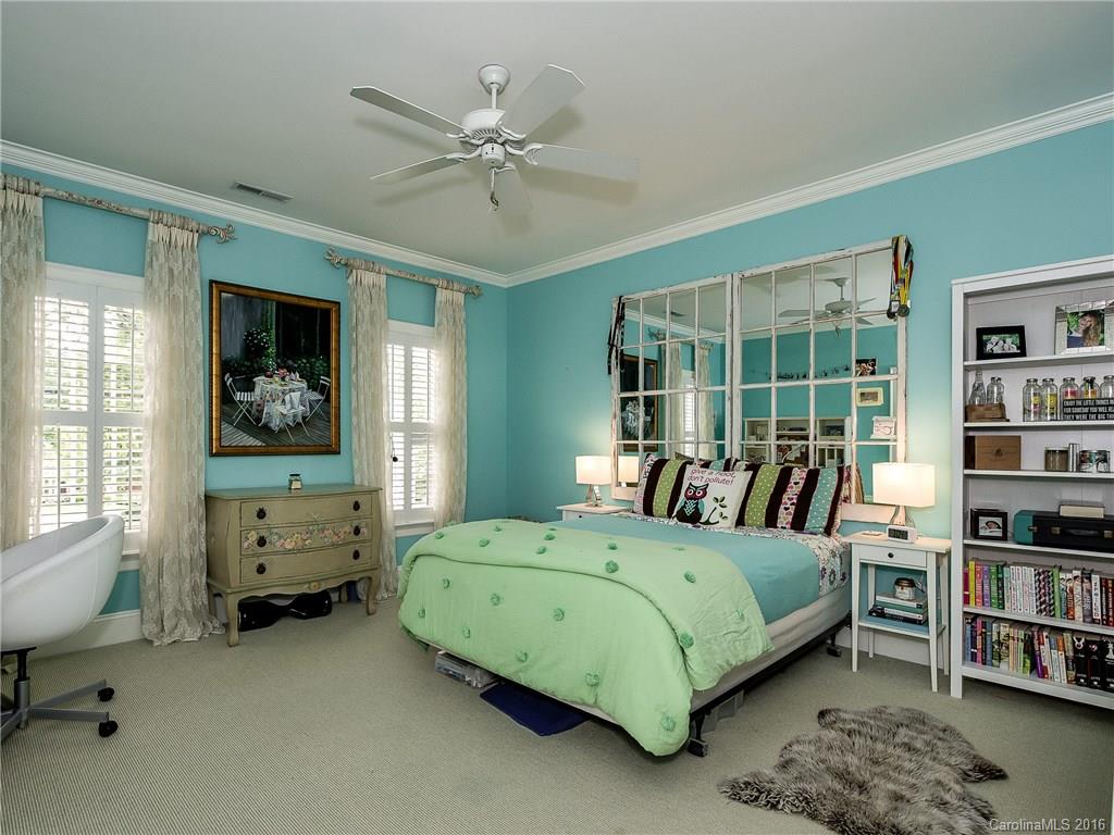 2419 Overhill Road Charlotte, NC 28211 - Photo 15 of 24 a bedroom with a bed a bookshelf and a bookshelf