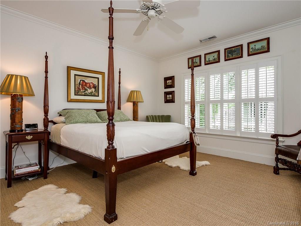 2419 Overhill Road Charlotte, NC 28211 - Photo 17 of 24 a bedroom with a bed and a chandelier