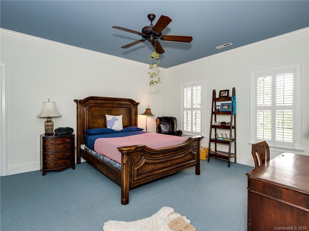 2419 Overhill Road Charlotte, NC 28211 - Photo 18 of 24 a bedroom with a bed and a chandelier