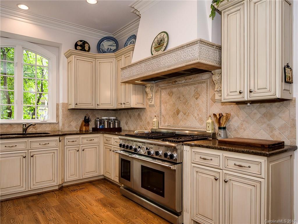 2419 Overhill Road Charlotte, NC 28211 - Photo 9 of 24 a kitchen with stainless steel appliances granite countertop a stove a sink and a microwave