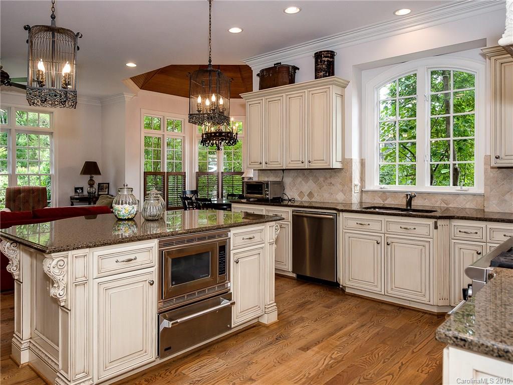 2419 Overhill Road Charlotte, NC 28211 - Photo 10 of 24 a kitchen with stainless steel appliances granite countertop a stove a sink and a white wooden cabinets
