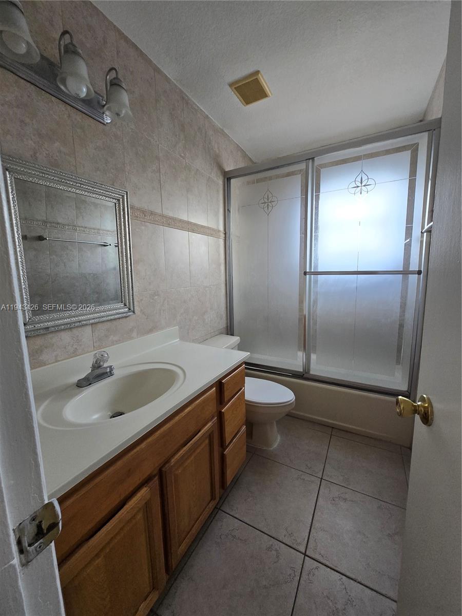 12850 Southwest 43rd Drive, Unit 250B Miami, FL 33175 - Photo 5 of 12 a bathroom with a sink toilet and shower