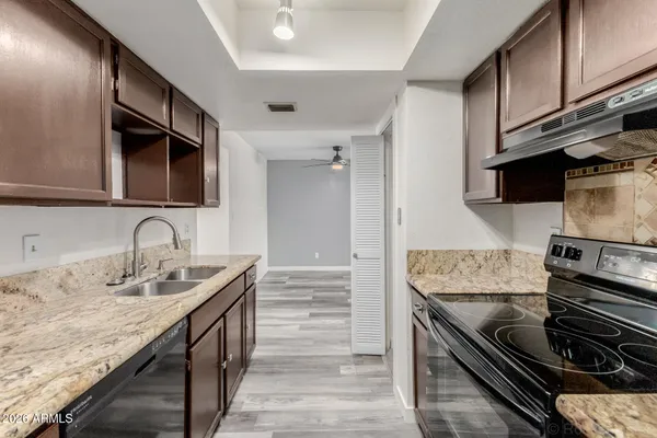 a view of an empty room and a ceiling fan