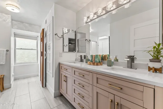 a spacious bathroom with a granite countertop sink a mirror and a